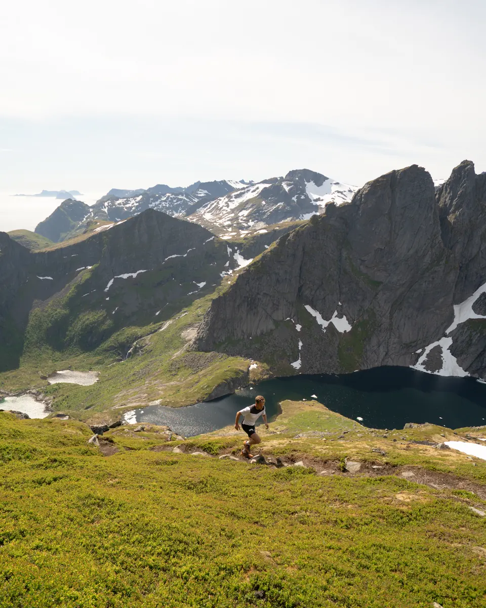 Before: a hiker above a mountain lake